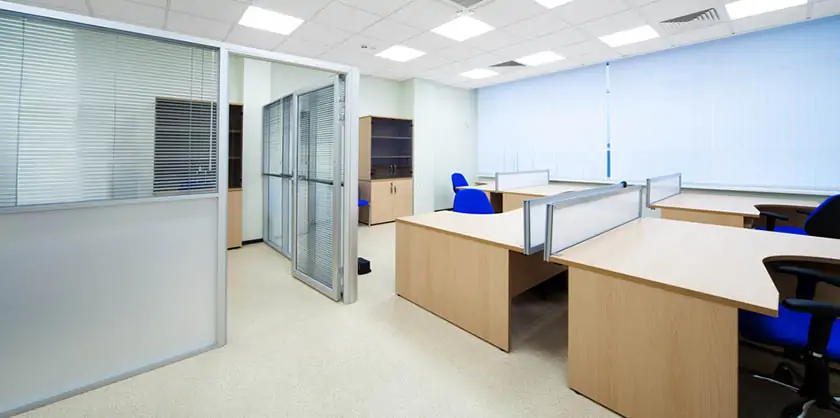 Refurbished office with partitioned workstations and blue chairs