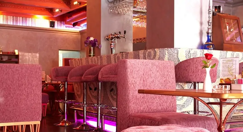 Refurbished pub interior with upholstered seating, a bar counter and warm lighting