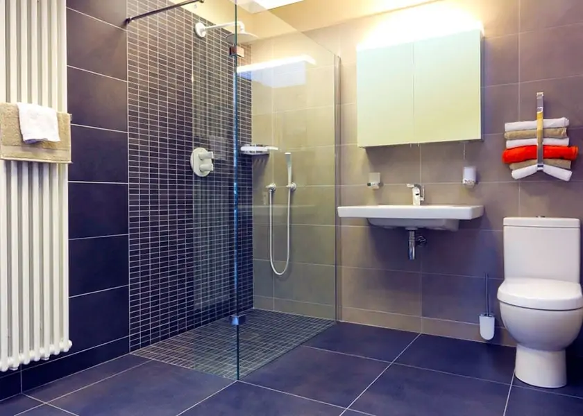 Modern wetroom with a walk-in shower, glass screen, wall-mounted basin and toilet