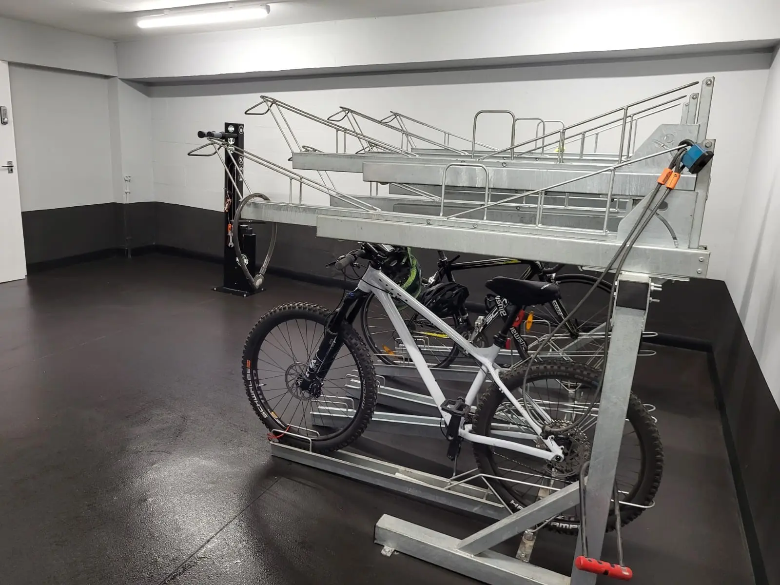 Bicycles stored on a metal rack in a refurbished bike store